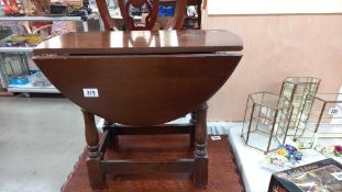 A dark oak drop leaf coffee table COLLECT ONLY