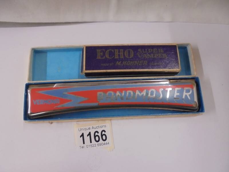 A Vermona Bandmaster harmonica and a Hohner Echo Superstomper harmonica.