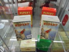 Two boxed Rupert money boxes.