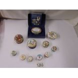 A collection of Halycon Days enamel pill boxes.