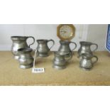 Seven antique pewter graduated measures.