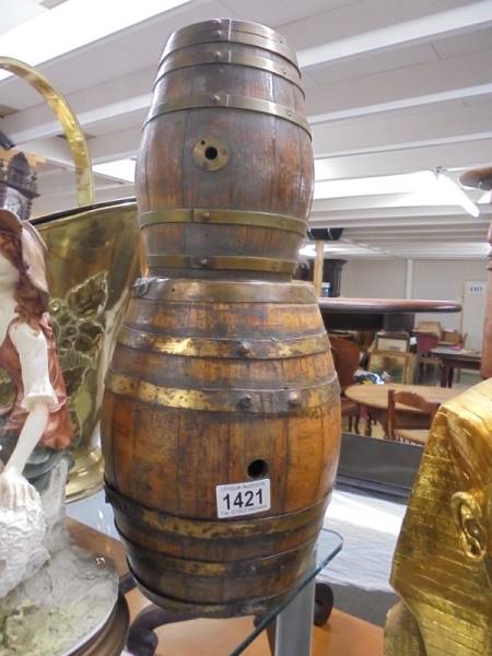 A wooden barrel and a smaller example.