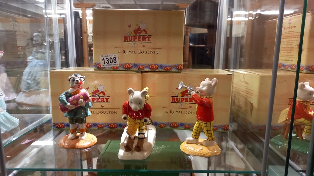 3 boxed Royal Doulton Rupert figures "Rupert Takes a Flying Lesson", "Ruperts Silver Trumpet"