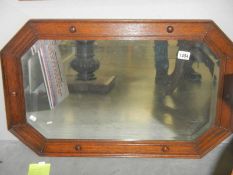 An Edwardian oak framed bevel edged mirror, 82 x 52 cm, COLLECT ONLY.
