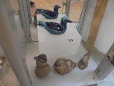 Four Poole pottery bird figures.