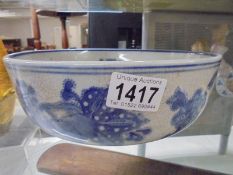 A heavily crazed blue and white bowl.