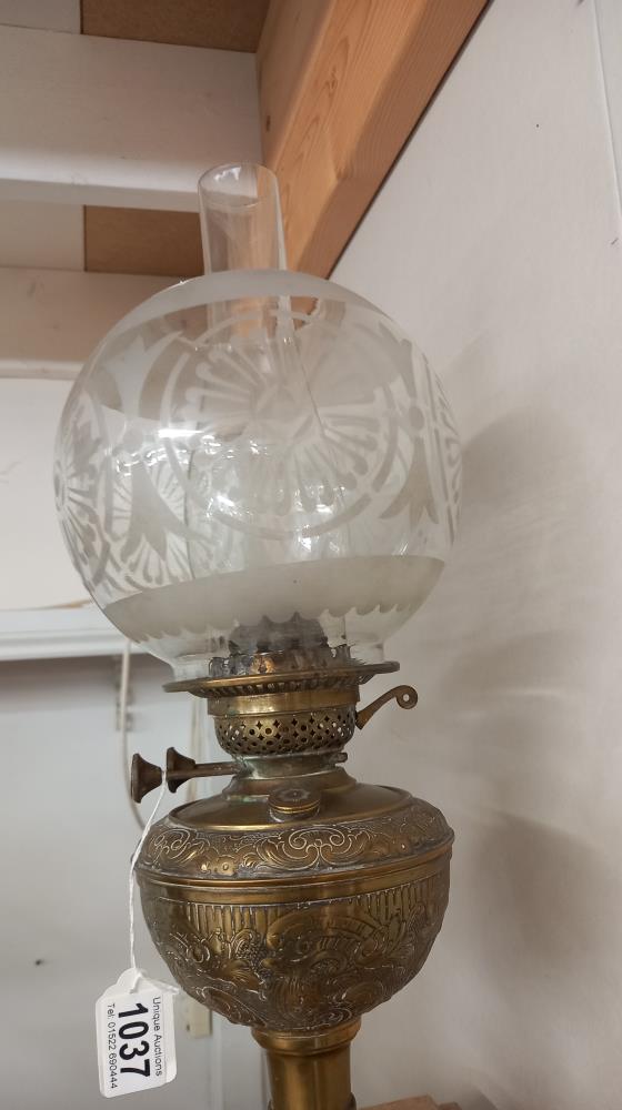 A Victorian oil lamp with embossed brass base and original etched shade. COLLECT ONLY. - Image 3 of 3
