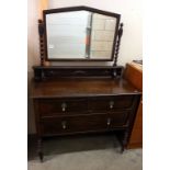 A 1930's oak mirror back dressing table. 107cm x 50cm x 82cm high, mirror 153cm