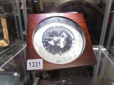 A mahogany cased Seiko world clock.