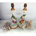 A pair of porcelain table lamps featuring boy and girl figures.