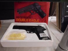 A boxed air soft pistol.