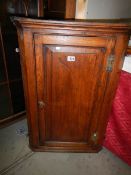 A Victorian oak corner cupboard with key. COLLECT ONLY.