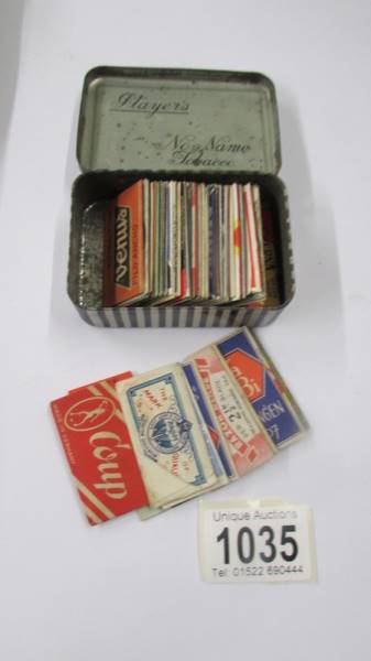 Fifty vintage razor blades in a Player's tobacco tin.
