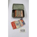 Fifty vintage razor blades in a Player's tobacco tin.