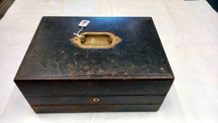 A wooden travelling writing slope and stationary box bound with embossed black leather, circa