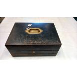 A wooden travelling writing slope and stationary box bound with embossed black leather, circa