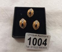 An 18ct gold diamond and sapphire pendant and earring set, 7.3 grams