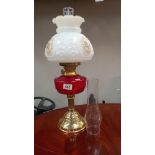 A Victorian style oil lamp with ruby glass font COLLECT ONLY