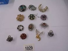 A good lot of vintage brooches and two dress rings.