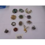 A good lot of vintage brooches and two dress rings.