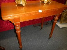 A light oak fold over tea table. COLLECT ONLY.