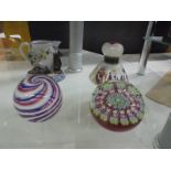 A millifiori paperweight, another paperweight, a scent bottle and a jug.