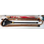 An unusual wind instrument walking stick, other walking sticks including a seat stick COLLECT ONLY