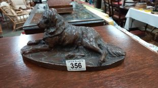 A bronzed figure of a dog (possibly a Newfoundland)