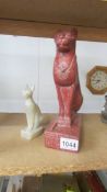 A mid 20th century statue of the Egyptian goddess 'Bastet' and a smaller example.