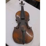 An old violin with face feature (in need of restoration).