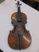 An old violin with face feature (in need of restoration).