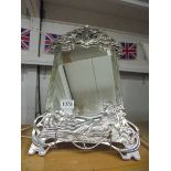 An art nouveau style mirror in white metal featuring a reclining lady.