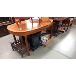 An extending teak dining table COLLECT ONLY