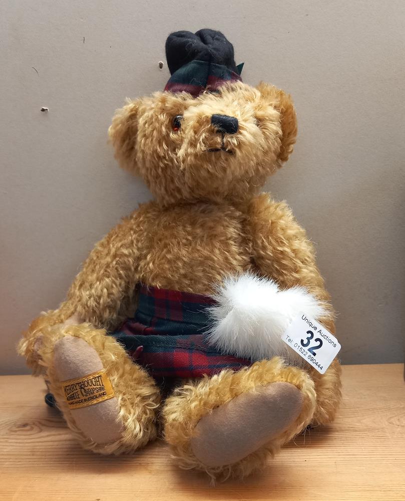 A Merrythought bear in a kilt and with growler