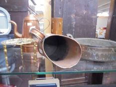 A copper pot, vase, scoop, pot and a brass trivet.