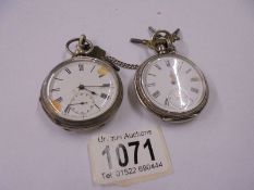 Two silver pocket watches, working but need attention, with silver chain and keys.