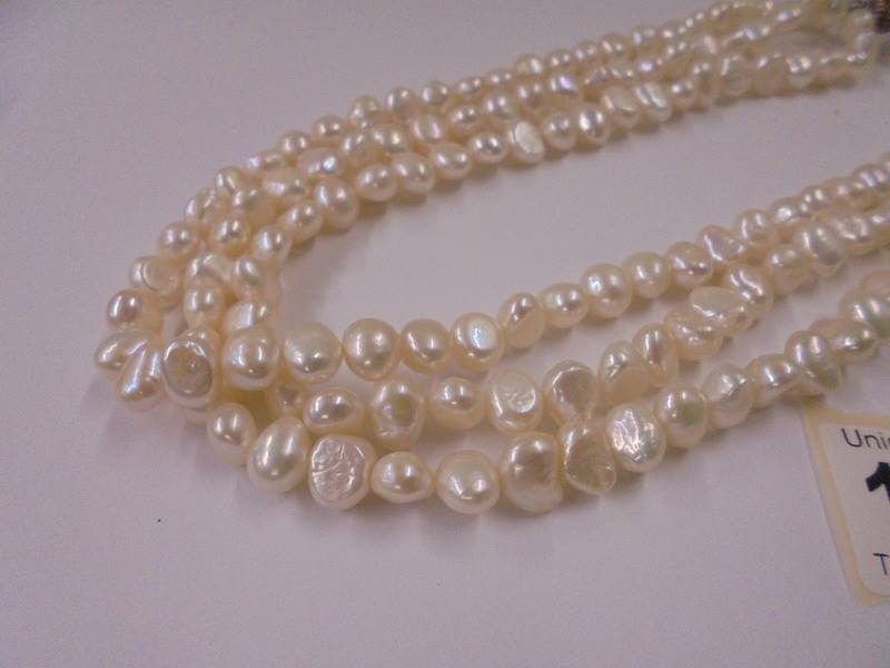 A three row natural pearl necklace. - Image 2 of 2