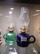 A Bristol blue glass and a green glass finger oil lamps.