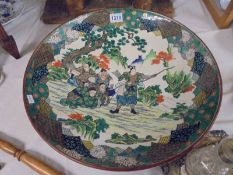 A large hand painted Chinese charger, 45.5 cm diameter (has age related crazing).