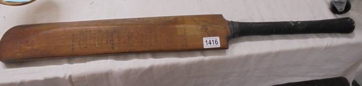 A vintage signed cricket bat including Harold Larwood.