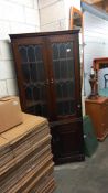 A dark oak corner cupboard with leaded glass doors COLLECT ONLY