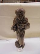 A carved wood figure of a boy (30cm tall)