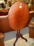 An oval mahogany tripod table. COLLECT ONLY.