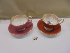 A pair of Aynsley floral tea cups and saucers.