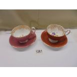 A pair of Aynsley floral tea cups and saucers.