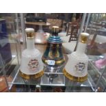 Three Wade Whisky Bell - Births of Princes William and Harry plus one other, with some contents.