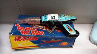 A boxed tinplate The Milky Way boat MF215, made in China and a vintage space gun