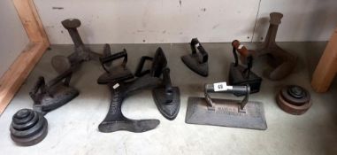 A Thomas Padmore and sons billiard table iron and selection of cast iron boot lasts, flat irons