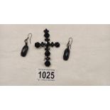 A black stone cross brooch (pin a/f) and a pair of black stone earrings, (possibly Whitby jet).