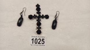 A black stone cross brooch (pin a/f) and a pair of black stone earrings, (possibly Whitby jet).